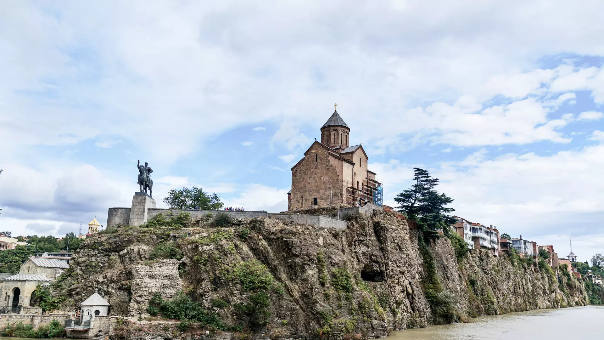 "Metekhi Church, a 13th century Georgian Orthodox Church with a white stone exterior and a distinctive conical dome, located in the historic district of Tbilisi, Georgia."